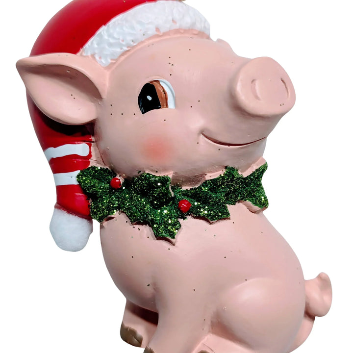 Sitting Pink Pig Ornament Wearing Red Santa Hat with Holly